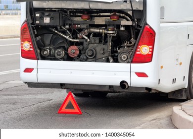 modern bus emergency stop for maintenance with open engine cover and triangle emergency sign on city street detailed closeup view of back side of white coach and motor bay interior travel concept - Shutterstock ID 1400345054