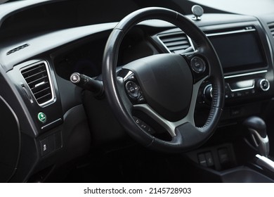 Modern Business Car Interior With Dashboard Panel And Steering Wheel. Driver Seat View.