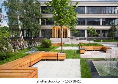 Modern Business Center With A Green Park With Benches And Fountains