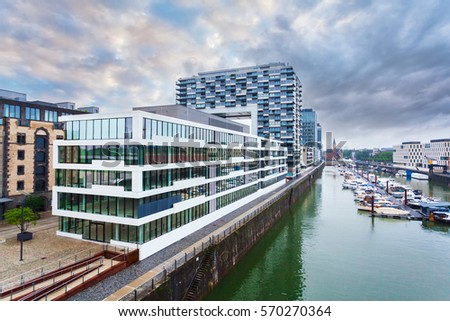 Modern business center on blue sky background in Cologne, Germany. Cologne Kranhaus - modern complex of buildings on the bank of Rhine with beautiful panoramic views in blue tones.