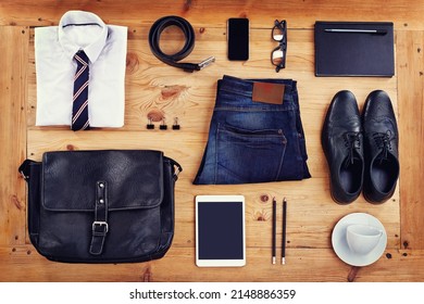 Modern business essentials. High angle shot of a stylish business outfit laid out on a wooden table.