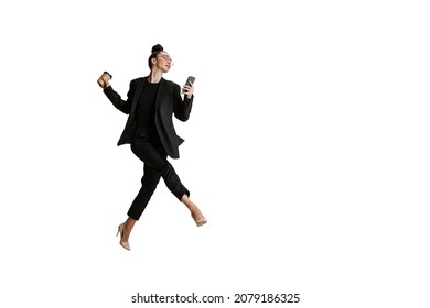 Modern Business Lady In Black Suit. Studio Shot Of Young Woman In Business Style Attire With Phone And Coffee Working Isolated On White Background. Art, Sport, Beauty, Fashion Concept. Copy Space For