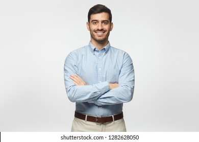 Modern Business Man In Casual Blue Shirt Standing With Crossed Arms, Isolated On Gray Background