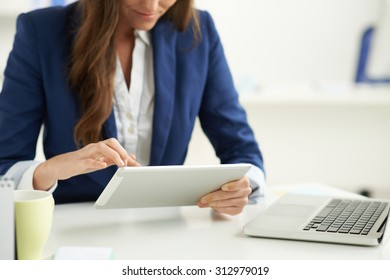 Modern business: manager using tablet computer her workplace
