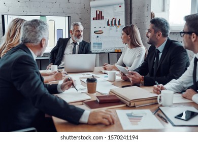 Modern business people communicating with each other while working together in the board room                       - Shutterstock ID 1570241194