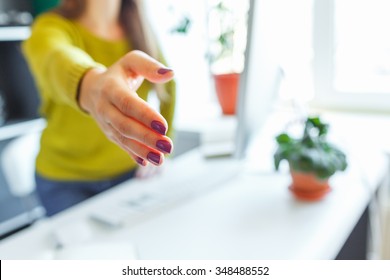 Modern Business Woman With Arm Extended To Handshake