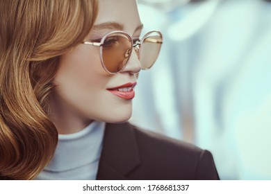 Modern business woman in formal clothes and sunglasses. Beauty, fashion. Optics and eyewear style. Close-up portrait.