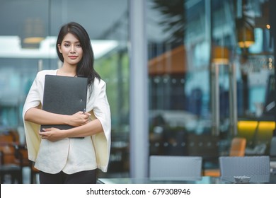 Modern business woman in the office with copy space, beautiful woman on the background of business people, Successful business woman looking confident and smiling.