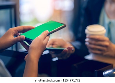 Modern Business Woman Order Hot Coffee From Barista And Using Smartphone To Pay By Scanning QR Code In Coffee Shop. Modernization Society Cashless, No Cash. Easy Payment For New Social Network