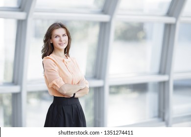 Modern Business Woman Standing Near A Large Window In The Office.