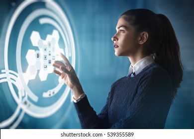 Modern Business Woman Using Innovative Technologies To Manage Her Administrative Work, Using A Digital Hologram Erp System