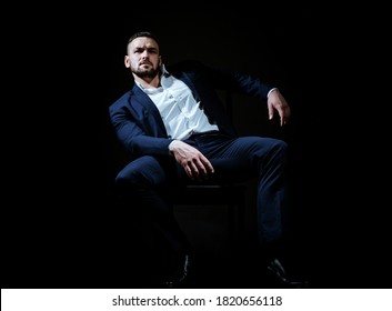 Modern Businessman. Confident Young Man In Suit Isolated On Black