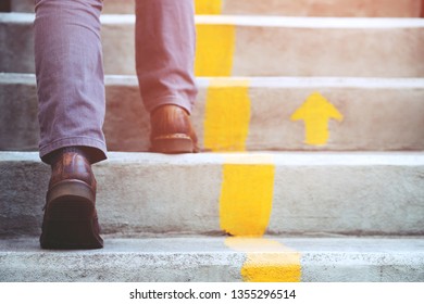 Modern Businessman Working Close-up Legs Walking Up The Stairs In Modern City. In Rush Hour To Work In Office A Hurry. During The First Morning Of Work. Stairway
