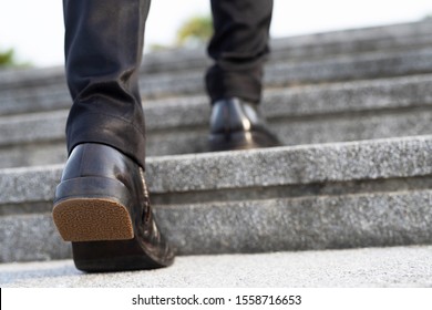 Modern Businessman Working  Close-up Legs Walking Up The Stairs In Modern City. In Rush Hour To Work In Office A Hurry. During The First Morning Of Work. Stairway. Soft Focus.