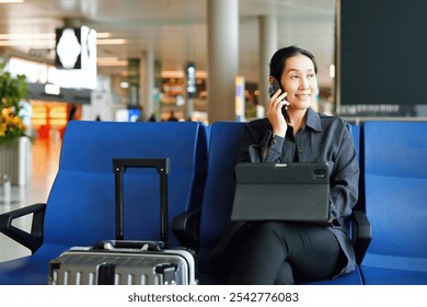 Modern Businesswoman Engaging with Technology at the Airport   - Powered by Shutterstock