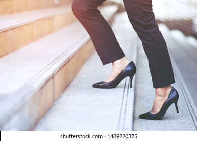 Modern Businesswoman Working Woman Close Up Legs Walking Up The Stairs In Modern City In Rush Hour To Work In Office A Hurry. During The First Morning Of Work. Leave Space For Writing Descriptive Text