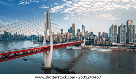 Modern cable-stayed bridge spanning the river with the urban cityscape in Chongqing, China.