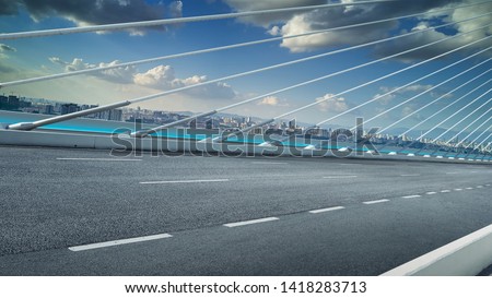 Modern cable-stayed bridge speedway with cityscape .Side angle view . Morning scene .