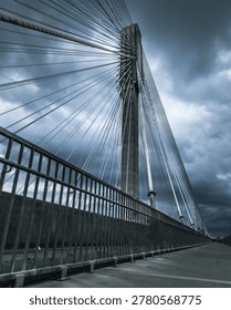 Modern Cable-Stayed Bridge Under Dramatic Stormy Sky | Stock Photo