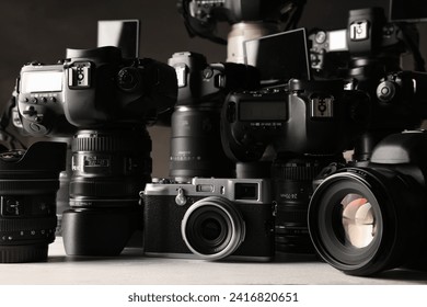 Modern cameras on white wooden table, closeup - Powered by Shutterstock