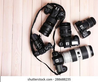 Modern cameras on wooden table, top view - Powered by Shutterstock