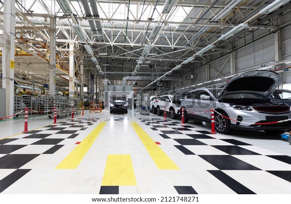 Modern car assembly\
plant. Auto industry. Interior of a high-tech factory, modern\
production of\
automobiles