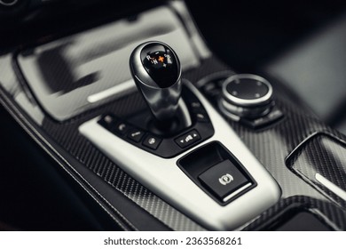 Modern car automatic gearbox shift handle and carbon panel - Shutterstock ID 2363568261