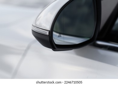 Modern car BCW system. Blind Spot Warning indicator on the car rearview mirror. Blind-spot collision warning.