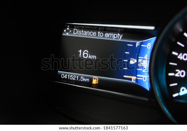 The modern car dashboard\
computer with color infographics shows the travel distance with the\
current amount of fuel in the tank. Color multi-function car\
display