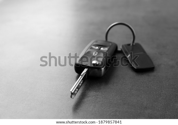 Modern car
flip key with trinket on grey
background