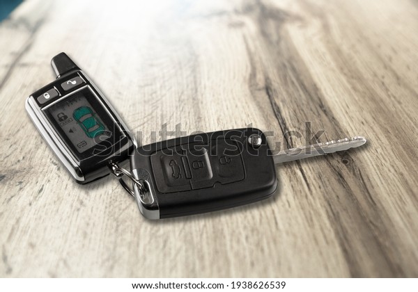 Modern car flip key\
with trinket on the desk