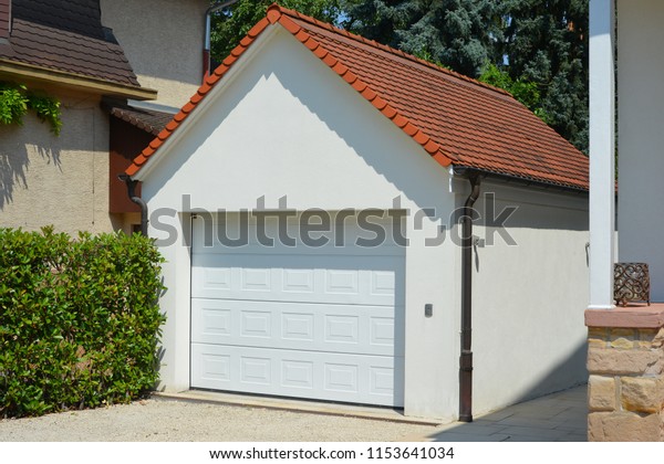 Modern Car Garage with automatic Door in Front\
of a Residential\
Building