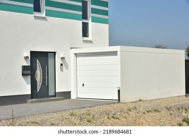 Modern Car Garage built of Concrete in Front of a residential Building
