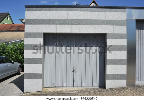 Modern Car Garage with Front of polished Granite\
Rock automatic Door