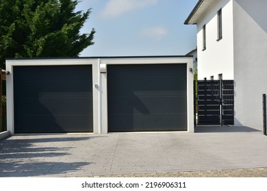 Modern Car Garage with remote-controlled automatic Door in Front of a residential Building
