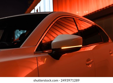 Modern car illuminated by evening lights close-up - Powered by Shutterstock