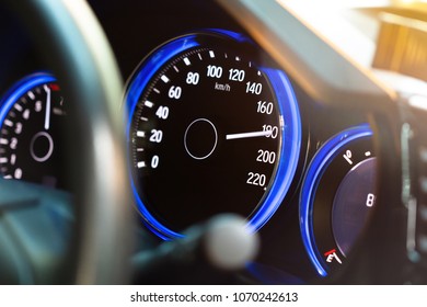 Modern car instrument panel dashboard with blue illuminated display, rev up. (Selective focus and shallow depth of field)