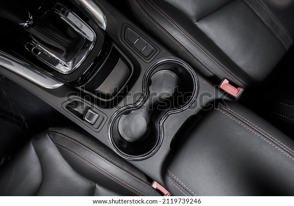 Modern Car Interior Central Console\
with Cup Holders and Front Seats. Automotive\
Theme.