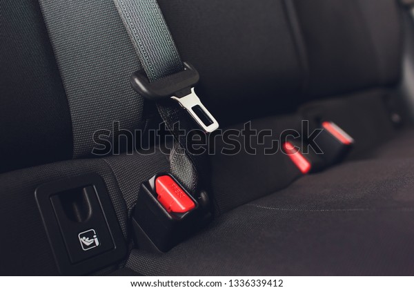 Modern car\
interior - rear seats with the seat\
belts.