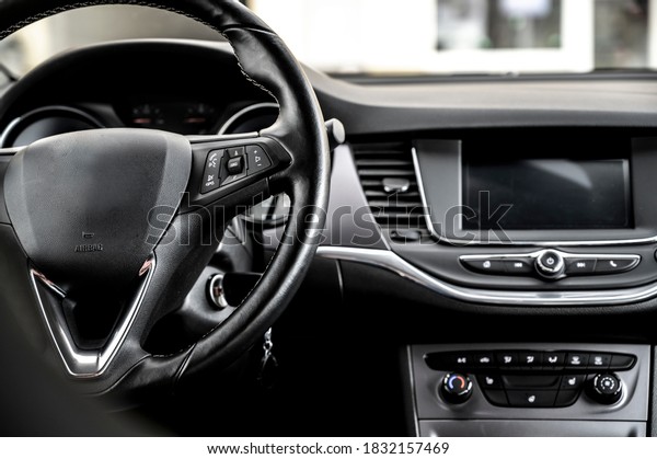 Modern car interior: steering wheel, gearshift\
lever, multimedia\
system.