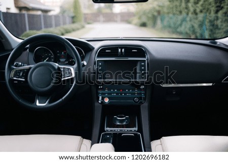Modern car interior. White leather seats and dashboard inside modern suv