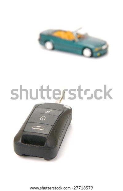 Modern car\
key isolated against a white\
background