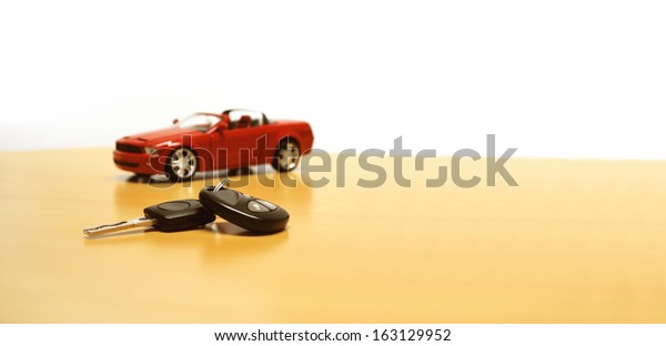 Modern car with its key next to it - perfect dealer
concept image