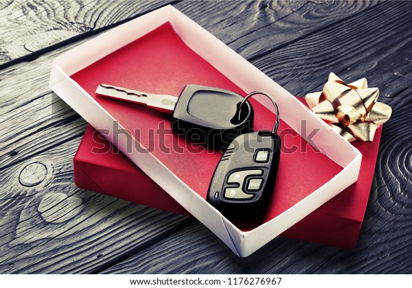 Modern Car keys  as a\
gift on  background