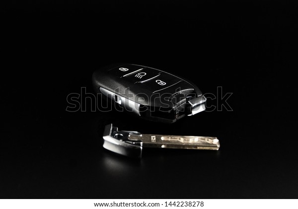 Modern car keys isolated on black background.Car\
key with remote alarm.