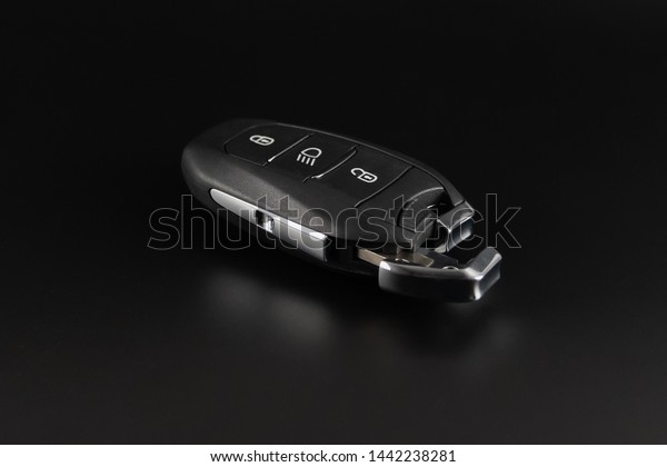 Modern car keys isolated on black background.Car\
key with remote alarm.