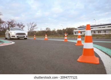 Modern Car On Driving School Test Track With Traffic Cones