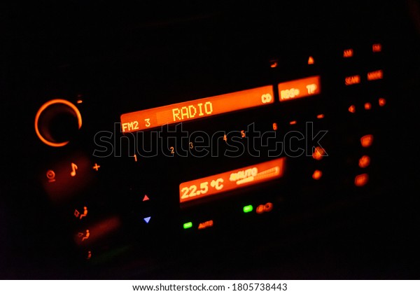 Modern car radio\
illuminated with orange\
color