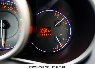 Modern Car Red Blue Illuminated Dashboard With Vehicle Mileage Closeup