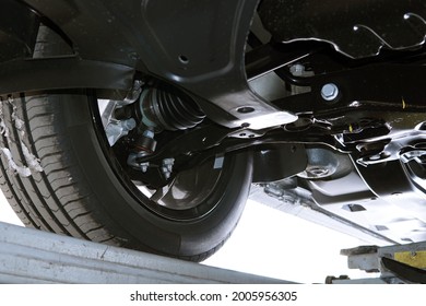 Modern car in a car service on a lift. Bottom view of the front suspension of the car. Selected focus.